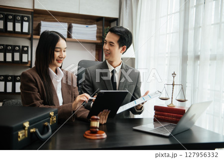 Business Asian people and lawyers discussing contract papers sitting at the table. Concepts of law, advice, legal services. Business Asian people and lawyers discussing contract papers sitting at the table. Concepts of law, advice, legal services. 127956332