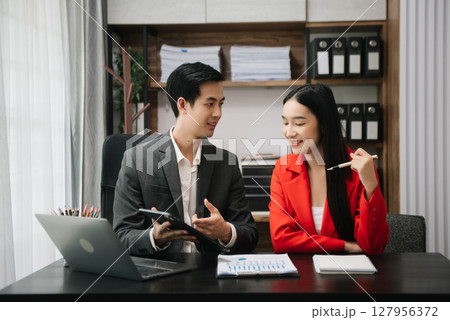 Team work process. Photo young business crew working with new startup project. Project managers meeting. Analyze plans, papers. At office Team work process. Photo young business crew working with new startup project. Project managers meeting. Analyze plans, papers. At office 127956372