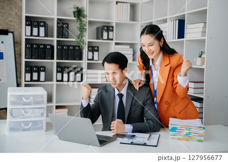 Young Asian business team creative businesspeople coworker, teamwork celebrating achievement and in planning design in office 127956677