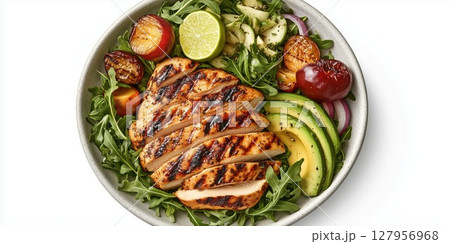 Grilled chicken salad with fresh vegetables, avocado, and lime served in a bowl 127956968