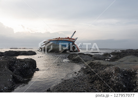 Old wrecked fishing boat on coast of Ang Sila Village, Saensuk Sub-district, Chonburi Province of thailand. Old wrecked fishing boat on coast of Ang Sila Village, Saensuk Sub-district, Chonburi Province of thailand. 127957077