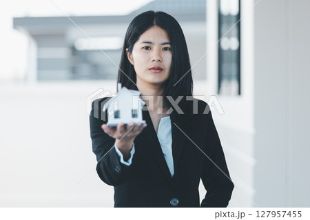 Woman hand hold key buy home model business concept involves sell financial management investment bank loan ownership income economy finance investments purchasing apartment blur background estate Woman hand hold key buy home model business concept involves sell financial management investment bank loan ownership income economy finance investments purchasing apartment blur background estate 127957455