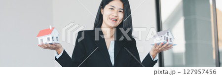Woman hand hold key buy home model business concept involves sell financial management investment bank loan ownership income economy finance investments purchasing apartment blur background estate Woman hand hold key buy home model business concept involves sell financial management investment bank loan ownership income economy finance investments purchasing apartment blur background estate 127957456
