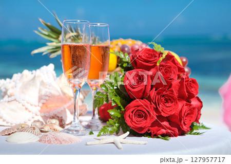 Celebrate love with roses, champagne, and seaside beauty. Perfect for wedding or engagement settings. Celebrate love with roses, champagne, and seaside beauty. Perfect for wedding or engagement settings. 127957717