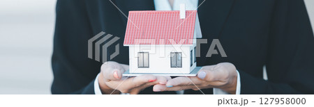 Woman hand hold key buy home model business concept involves sell financial management investment bank loan ownership income economy finance investments purchasing apartment blur background estate 127958000