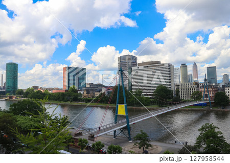 Frankfurt am Main skyline with skyscrapers and bridge over the Main river, Germany Frankfurt am Main skyline with skyscrapers and bridge over the Main river, Germany 127958544