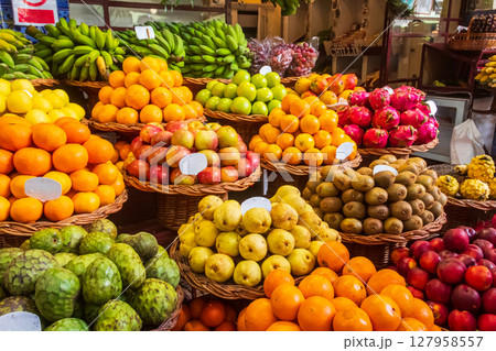 Fruit stall with various tropical fruits at Mercado dos Lavradores (Farmers' Market) in Funchal, Madeira, Portugal Fruit stall with various tropical fruits at Mercado dos Lavradores (Farmers' Market) in Funchal, Madeira, Portugal 127958557