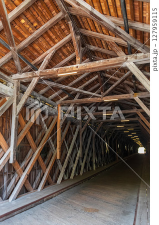 Inside the covered wooden old bridge (Alte Rheinbrucke) the across the river Rhine between Vaduz, Liechtenstein and Sevelen, Switzerland 127959115