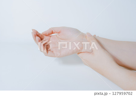 massage hand and finger after pain and ache in office working with white isolated background massage hand and finger after pain and ache in office working with white isolated background 127959702