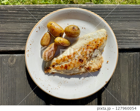 plate of grilled fish and potatoes plate of grilled fish and potatoes 127960054