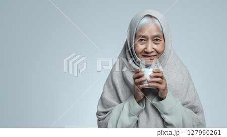 Indonesian grandmother smiles with milk 127960261