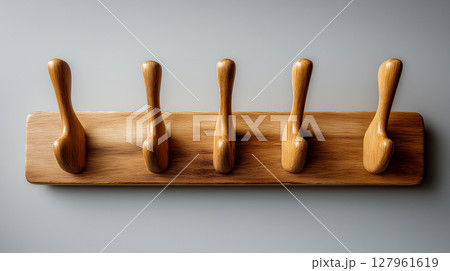 Wall mounted wooden coat rack on the wall 127961619