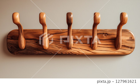 Wooden coat rack mounted on a smooth wall surface 127961621