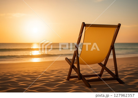 Empty Beach Chair Facing Sunset over the Sea 127962357