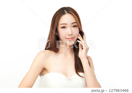 A beautiful young Asian woman with clean, fresh skin against a white background. Skincare, facial treatment, cosmetology, beauty, and spa. An elegant portrait of an Asian woman. A beautiful young Asian woman with clean, fresh skin against a white background. Skincare, facial treatment, cosmetology, beauty, and spa. An elegant portrait of an Asian woman. 127963466