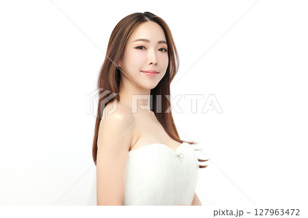 A beautiful young Asian woman with clean, fresh skin against a white background. Skincare, facial treatment, cosmetology, beauty, and spa. An elegant portrait of an Asian woman. A beautiful young Asian woman with clean, fresh skin against a white background. Skincare, facial treatment, cosmetology, beauty, and spa. An elegant portrait of an Asian woman. 127963472