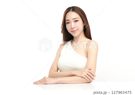 A beautiful young Asian woman with clean, fresh skin against a white background. Skincare, facial treatment, cosmetology, beauty, and spa. An elegant portrait of an Asian woman. 127963475