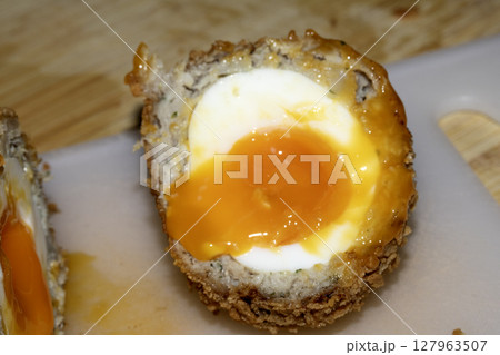 Crispy Scotch Egg Batter Fried Golden Close up with runny yolk Crispy Scotch Egg Batter Fried Golden Close up with runny yolk 127963507