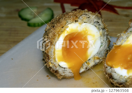Crispy Scotch Egg Batter Fried Golden Close up with runny yolk 127963508