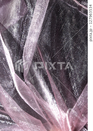 Close up of pink organza silk fabric in delicate waves for background Close up of pink organza silk fabric in delicate waves for background 127963534