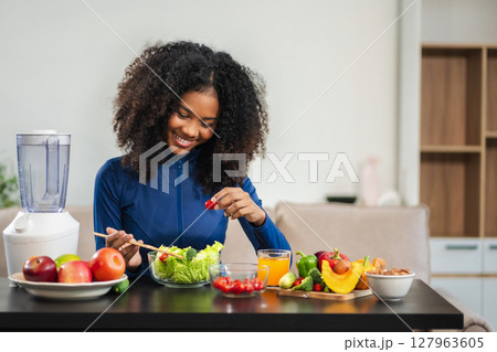 Fit woman enjoys healthy fruit breakfast after yoga training. fitness, nutrition, home lifestyle. 127963605