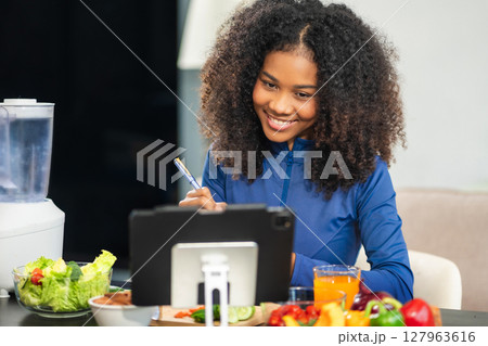 Fit woman enjoys healthy fruit breakfast after yoga training. fitness, nutrition, home lifestyle. Fit woman enjoys healthy fruit breakfast after yoga training. fitness, nutrition, home lifestyle. 127963616