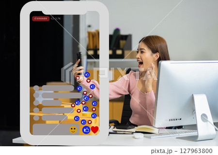 Asian vlogger woman influencer, SME retail store owner smile enjoy selling show live sale online screen smartphone work at home. Asian vlogger woman influencer, SME retail store owner smile enjoy selling show live sale online screen smartphone work at home. 127963800