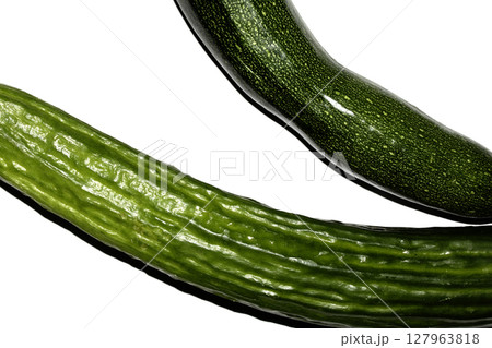 Close up of home grown cucumber courgette zucchini baby marrow vegetable skin green on white background Close up of home grown cucumber courgette zucchini baby marrow vegetable skin green on white background 127963818