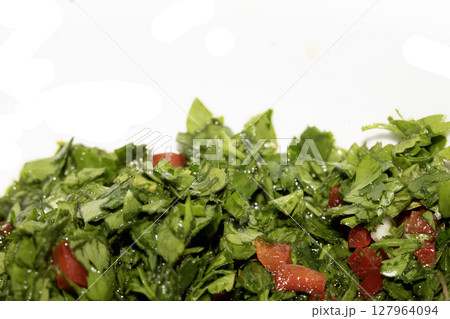 Close up of chimichurri herbs sauce marinade with spoon in a bowl healthy Close up of chimichurri herbs sauce marinade with spoon in a bowl healthy 127964094