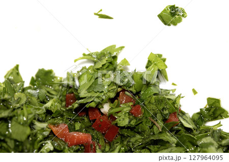 Close up of chimichurri herbs sauce marinade with spoon in a bowl healthy Close up of chimichurri herbs sauce marinade with spoon in a bowl healthy 127964095