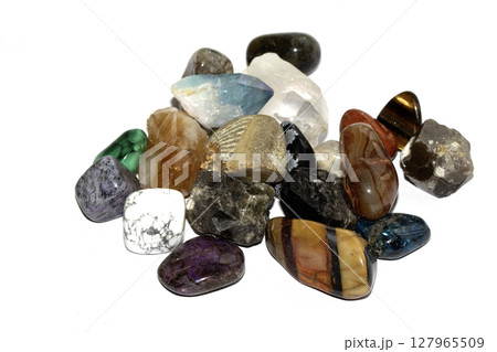Collection of holistic healing crystal pieces and rocks spiritual on a white background tigers eye and garnet 127965509