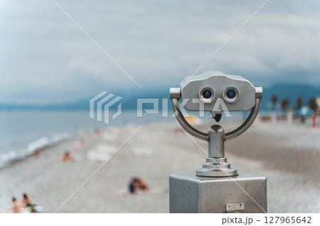 Seaside Binocular Viewer with Blurred Beach Background 127965642