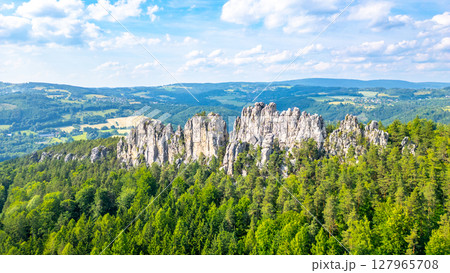 Discover the unique sandstone formations of Suche skaly in Bohemian Paradise, Czech Republic, surrounded by lush greenery and stunning landscapes on a sunny day. 127965708