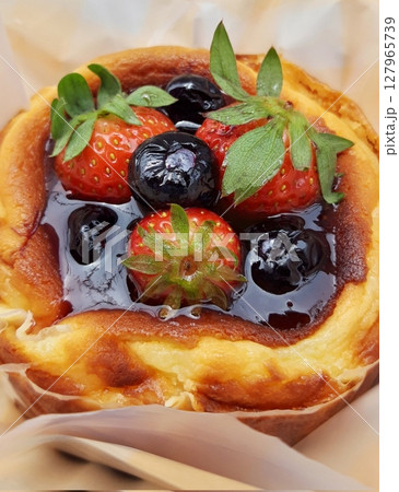 Rich and creamy burnt cheesecake with a perfectly caramelized top, crowned with fresh fruits for a delightful burst of flavor and texture in every bite. Rich and creamy burnt cheesecake with a perfectly caramelized top, crowned with fresh fruits for a delightful burst of flavor and texture in every bite. 127965739