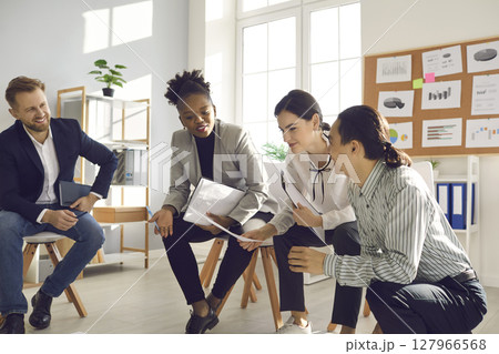 Team of business people working on project, discussing ideas, making suggestions 127966568