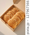 A box full of classic fluffy pancakes, showing their textured golden tops. Highlighting a delicious, ready-to-eat meal, great for cafes, bakeries, or delivery services.	 127967366