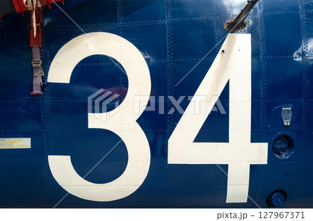 Blue aircraft fuselage with white number 34 and metal details Blue aircraft fuselage with white number 34 and metal details 127967371