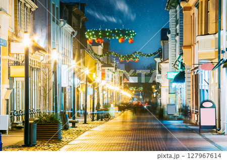 Parnu, Estonia. Night View Of Famous Ruutli Street With Old Buildings, Restaurants, Cafe, Hotels And Shops In Festive Evening Night Christmas Xmas New Year Illuminations . Night starry stars sky. 127967614