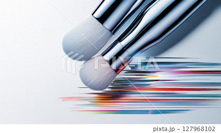 Close-up of silver makeup brushes with colorful strokes on white background 127968102