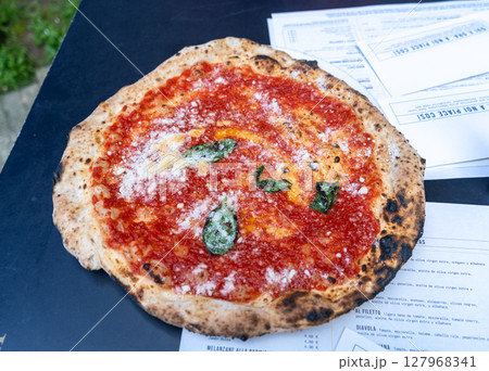 Fresh pizza with tomato, cheese, and basil 127968341