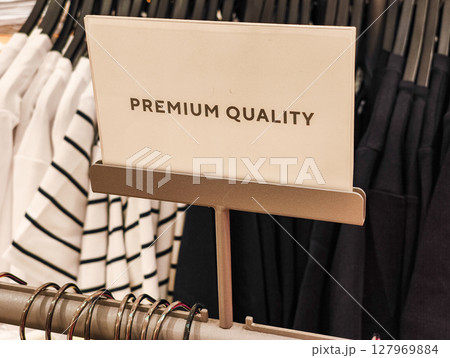 Premium quality sign displaying in clothing store Premium quality sign displaying in clothing store 127969884