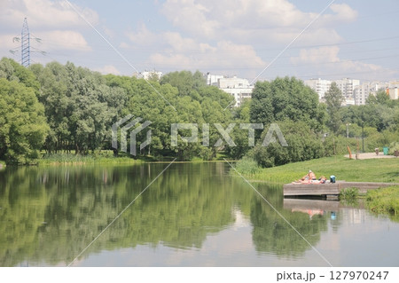 Summer sunset view of Yuzhnoe Butovo park in South Butovo district, Moscow, Russia. Summer sunset view of Yuzhnoe Butovo park in South Butovo district, Moscow, Russia. 127970247
