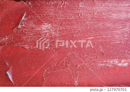 Wooden texture with cracked paint. texture of cracked from time painted red door 127970701