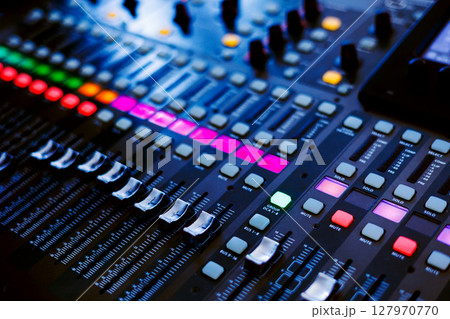 Concert sound mixer panel with volume regulators. Professional audio and light equipment for sound recording studio, live music broadcasting, television, party. mixing console. audio signals 127970770
