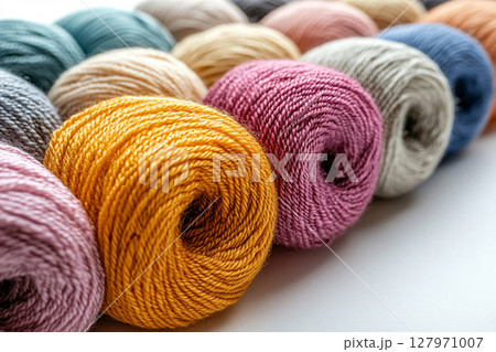 Winter Warmth. Colorful yarns for knitting on a white background. Copy space. Winter Warmth. Colorful yarns for knitting on a white background. Copy space. 127971007