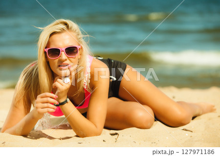 Beautiful blonde girl on beach, summertime Beautiful blonde girl on beach, summertime 127971186