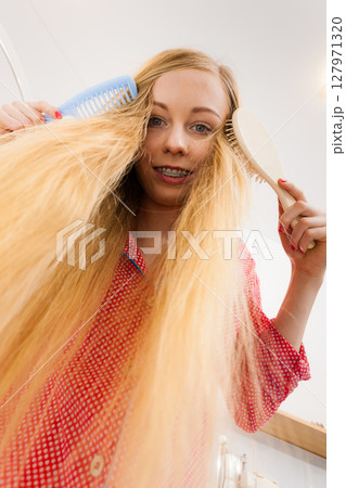 Woman with long windblown blonde hair 127971320