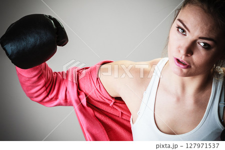 Sport boxer woman in black gloves boxing Sport boxer woman in black gloves boxing 127971537