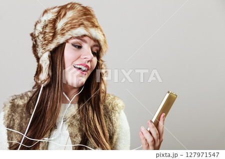 Winter girl listening music. Winter girl listening music. 127971547