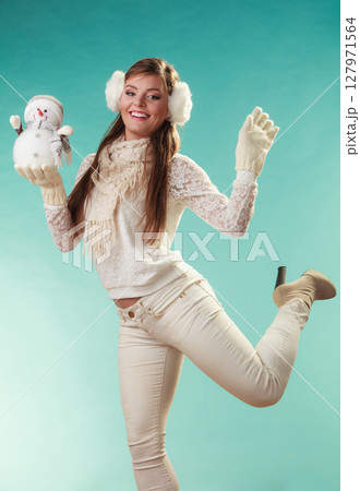Smiling cute woman with little snowman. Winter. 127971564